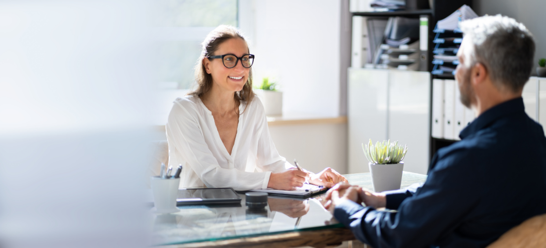 Woman sitting at a desk conducting a job interview